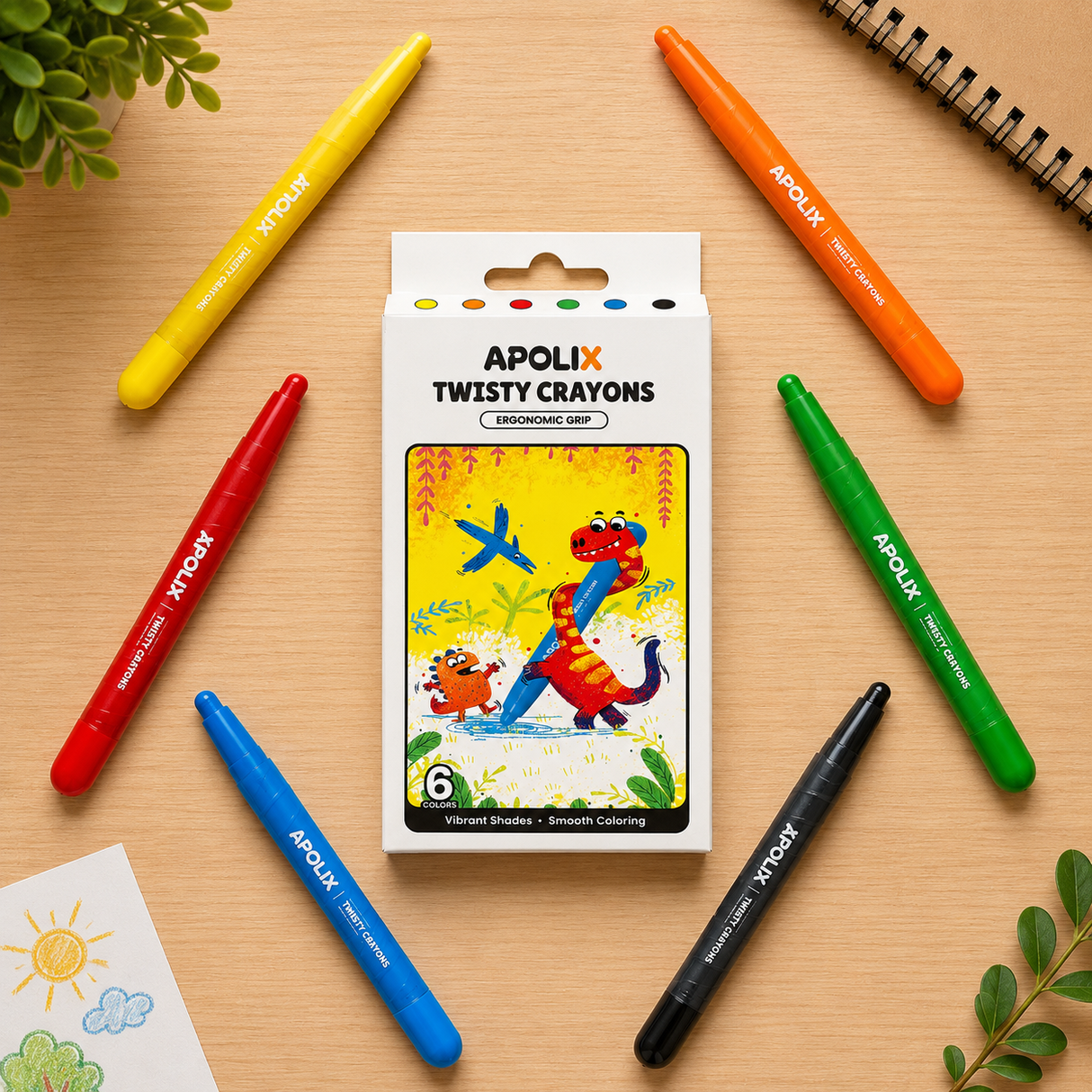 A boxed set of APOLIX Twisty Crayons centered on a light wood surface, surrounded by six colored crayons in yellow, orange, red, green, blue, and black. The package shows colorful cartoon dinosaur artwork and the text 'APOLIX TWISTY CRAYONS' and '6 Twisty Stripes + Smooth Coloring.