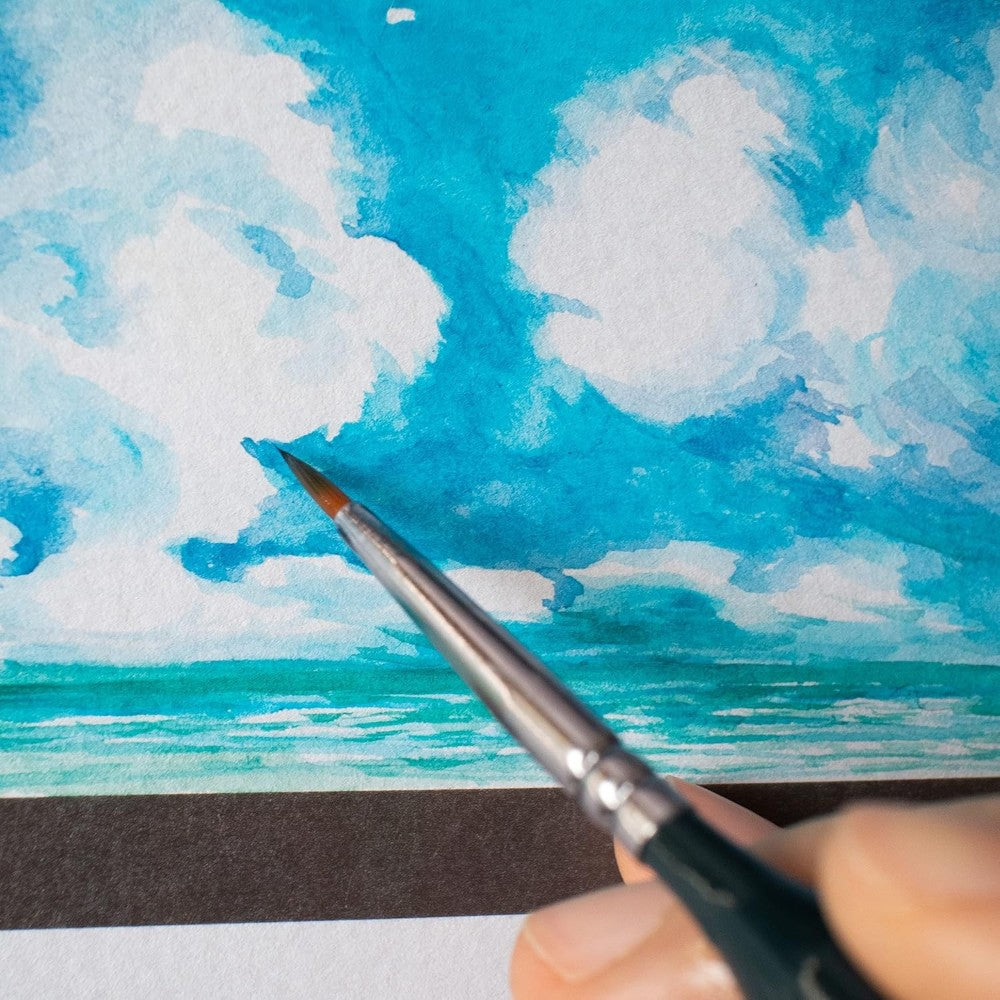 Artist using Mont Marte Fine Detail Brush for miniature painting