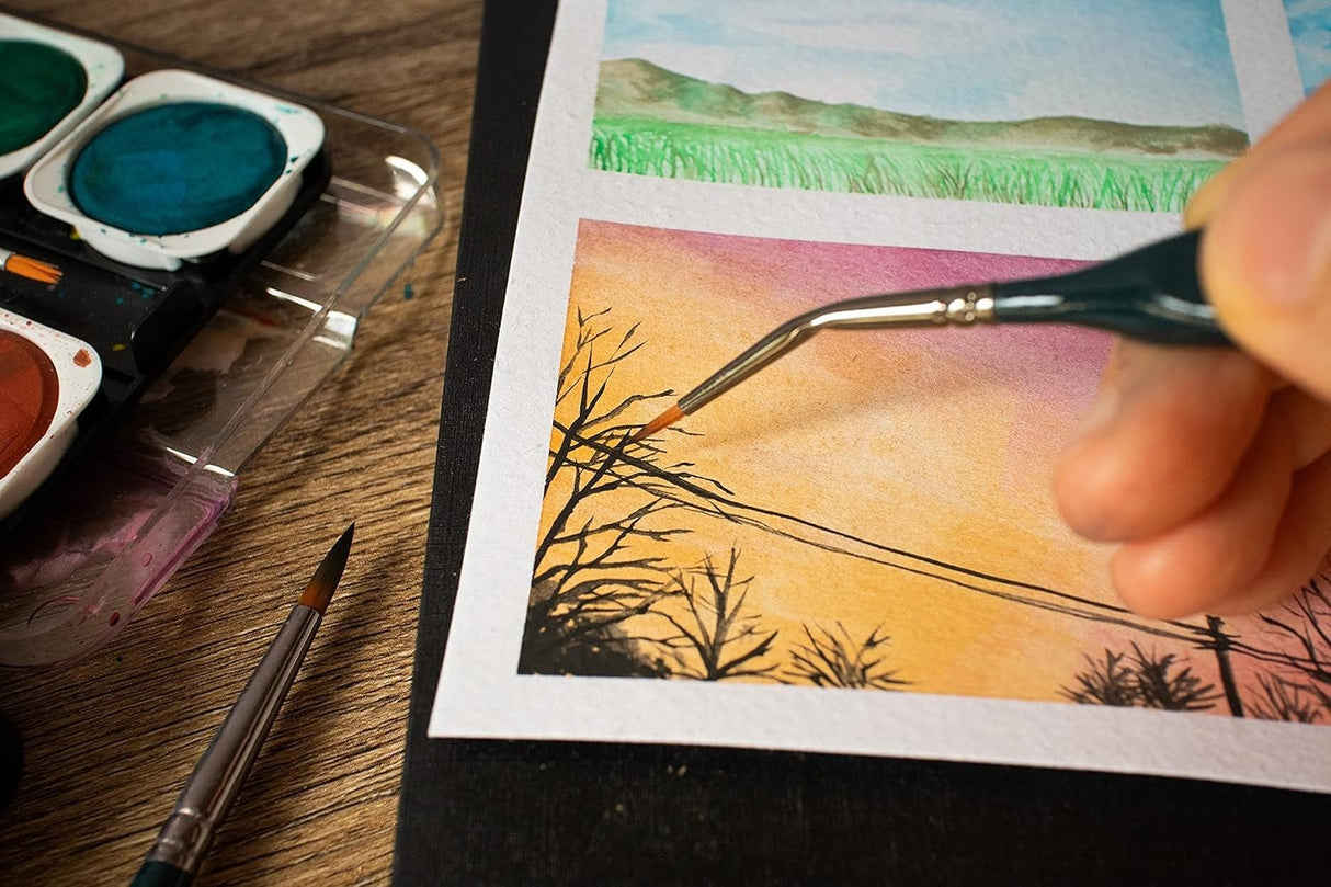 Close-up of hand using Mont Marte Detail Brush on fine artwork