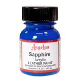 A small bottle of Angelus brand leather paint labeled "Sapphire" containing 1 fl. oz. (29.5 ml) of acrylic paint. The label advises to keep out of reach of children.  